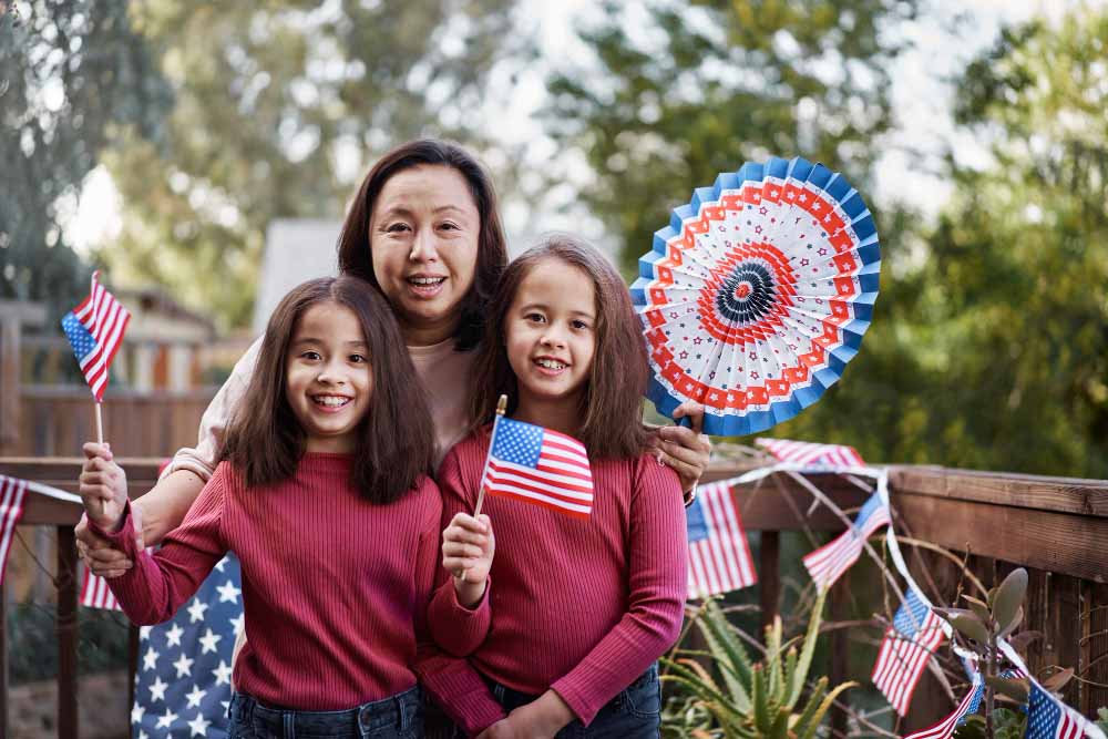 Happy family holding US flag