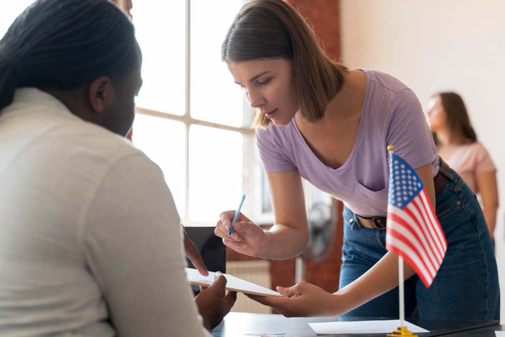 woman holding a pen to sign an immigration document